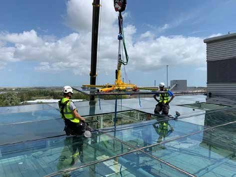 Installer securing architectural glazing on site